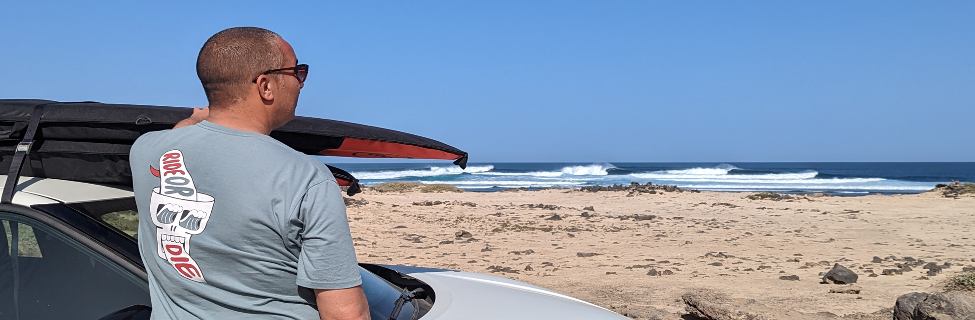 Dad watching kids stand up paddle board