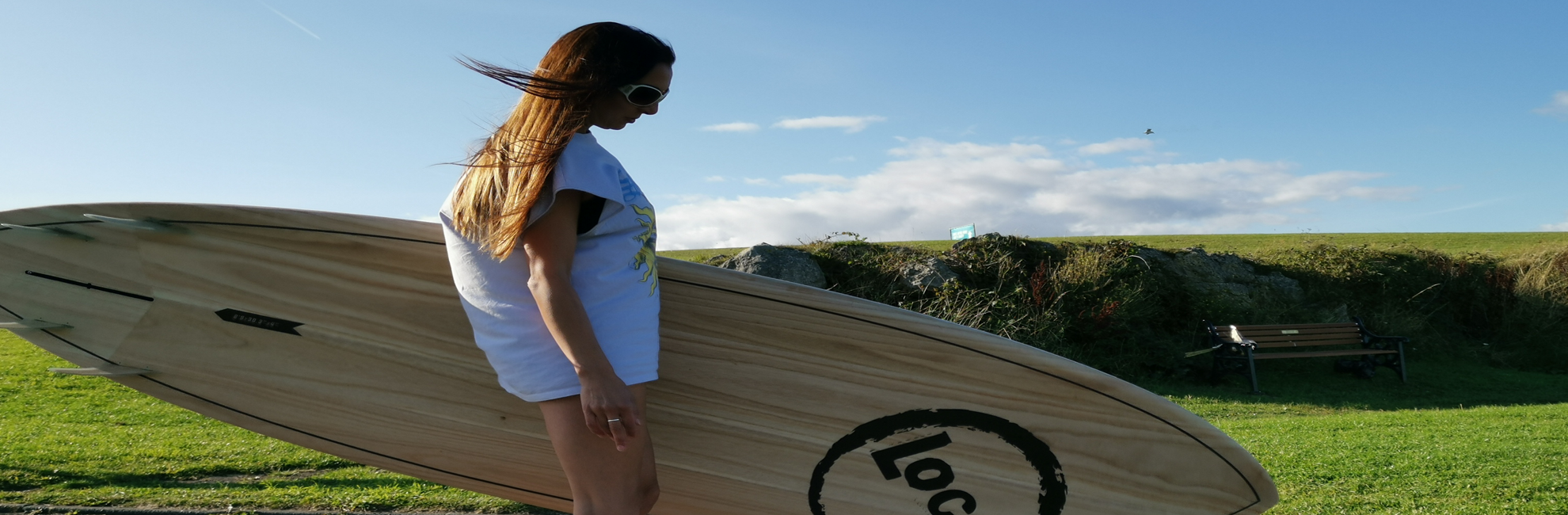 Girl with Surf SUP skating to UK beach to paddle board