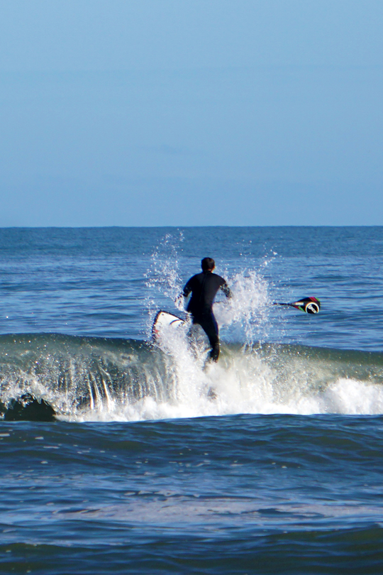 Dude heading out on his surfing paddle board