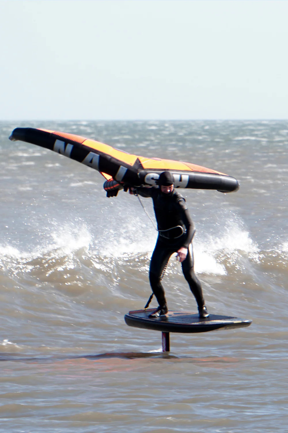 Wingfoiler on his hydrofoil board in the North East