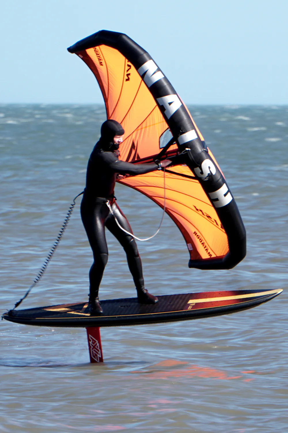 Guy winging on our downwind foil board