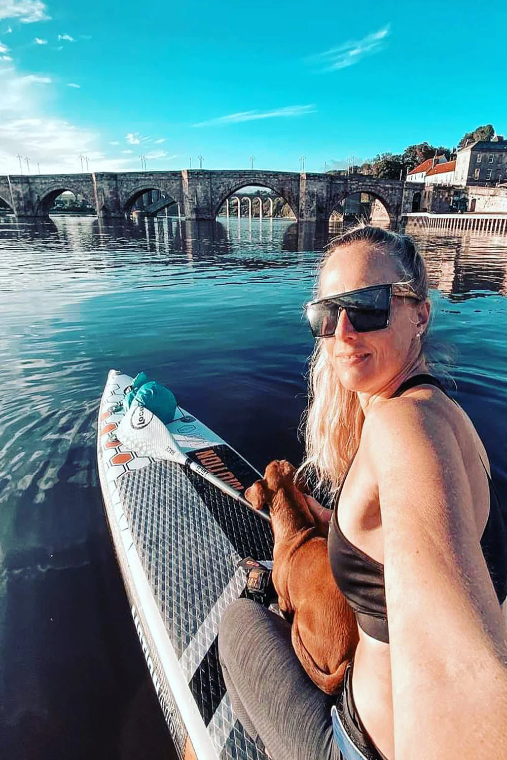 Girl And Sausage Dog Aboard her race board