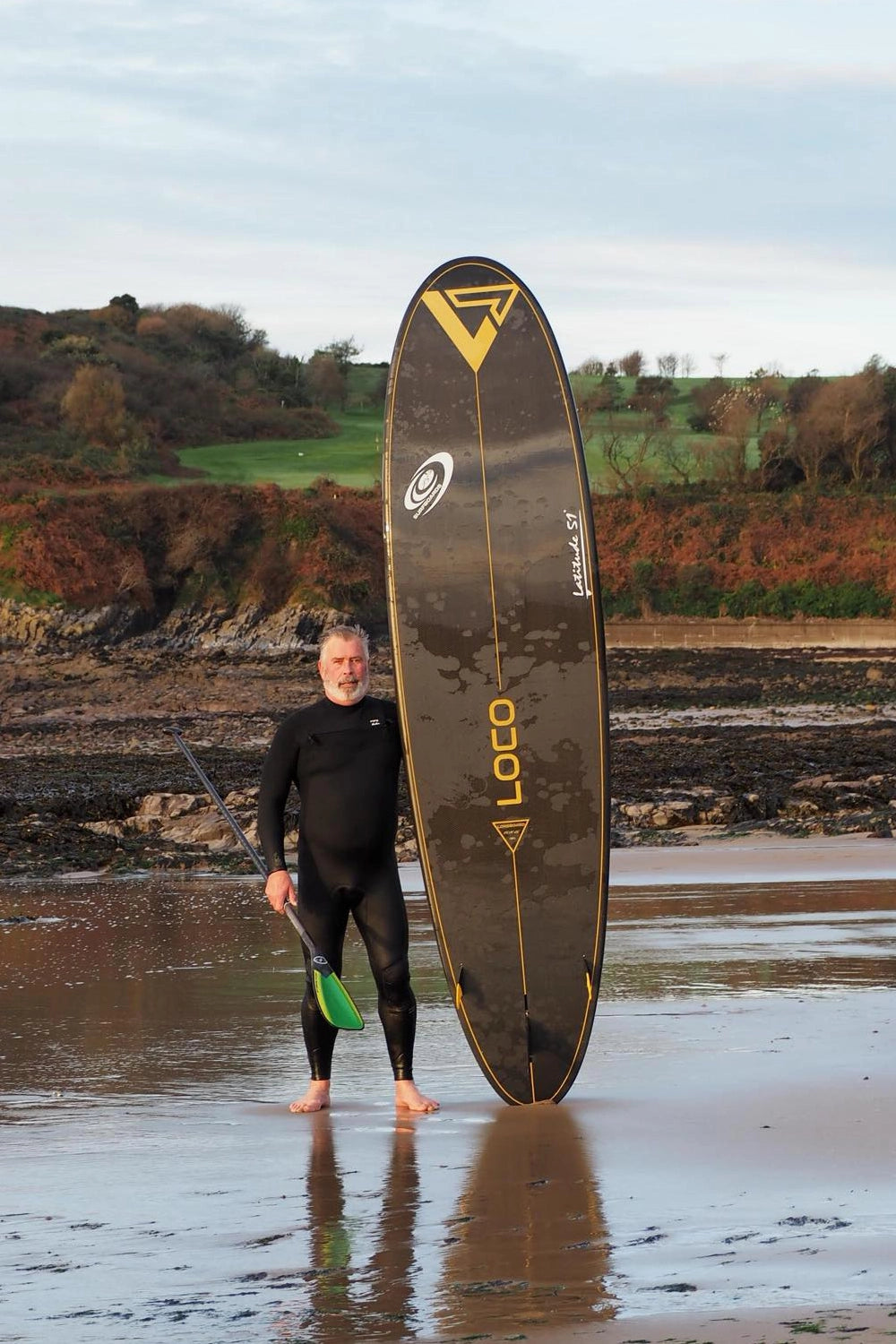 Guy standing with longboard surf SUP