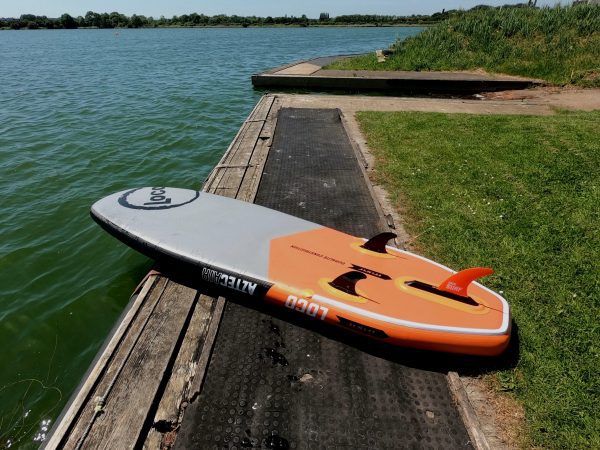 Inflatable paddle board resting on jetty