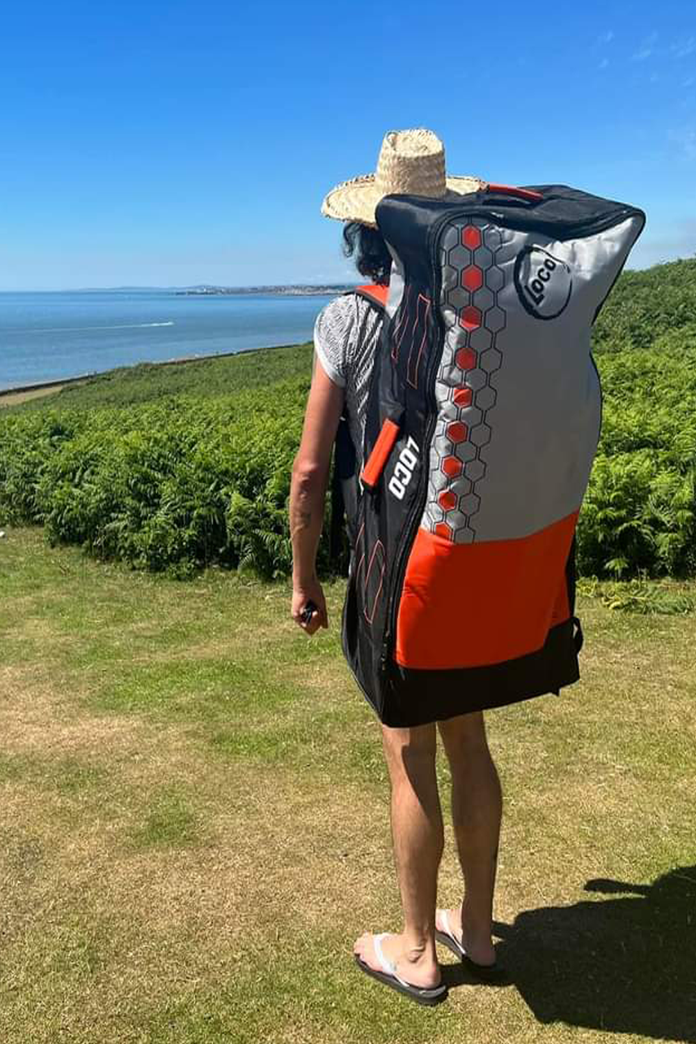 Dude carrying his Loco inflatable paddle board