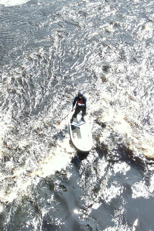river SUPer riding his whitewater SUP