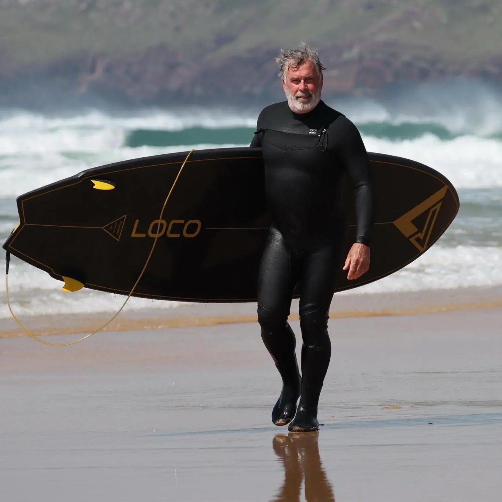 Guts riding his twin fin paddleboard