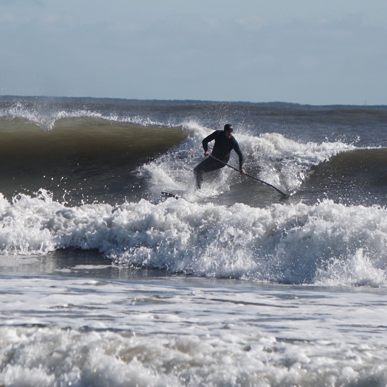 Joe riding his stand up paddle board in the North East surf