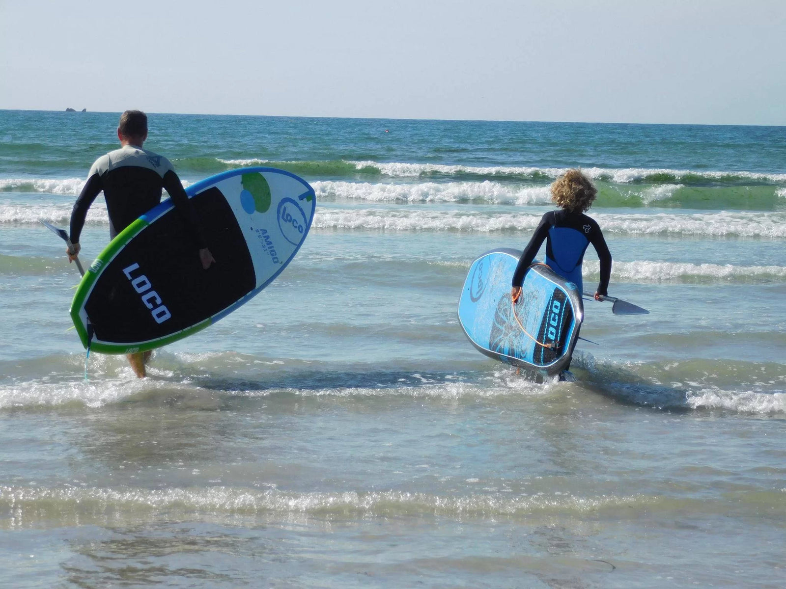 father and son paddle surfing
