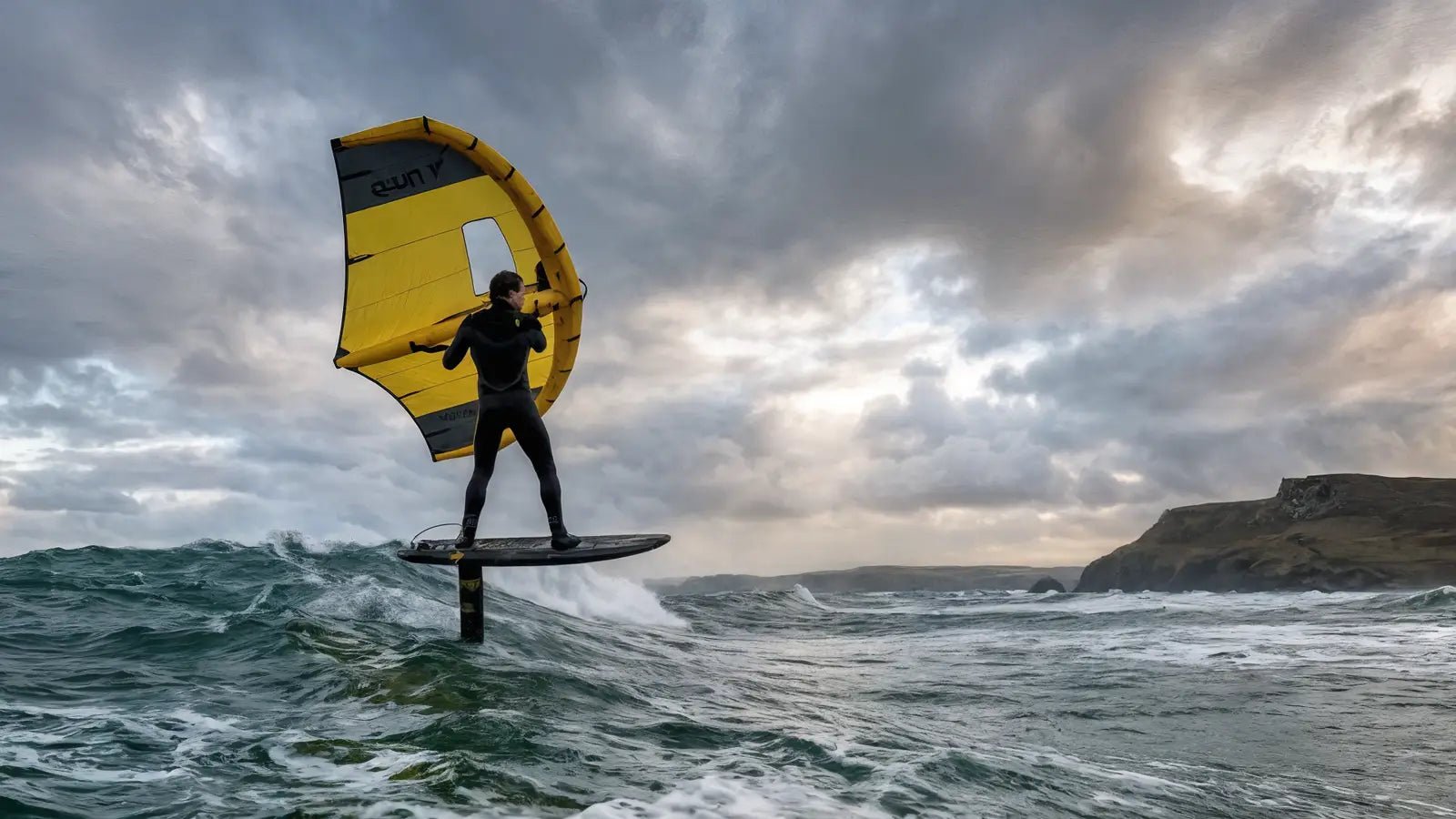 Rider wing foiling on a Loco foil board in UK coastal conditions