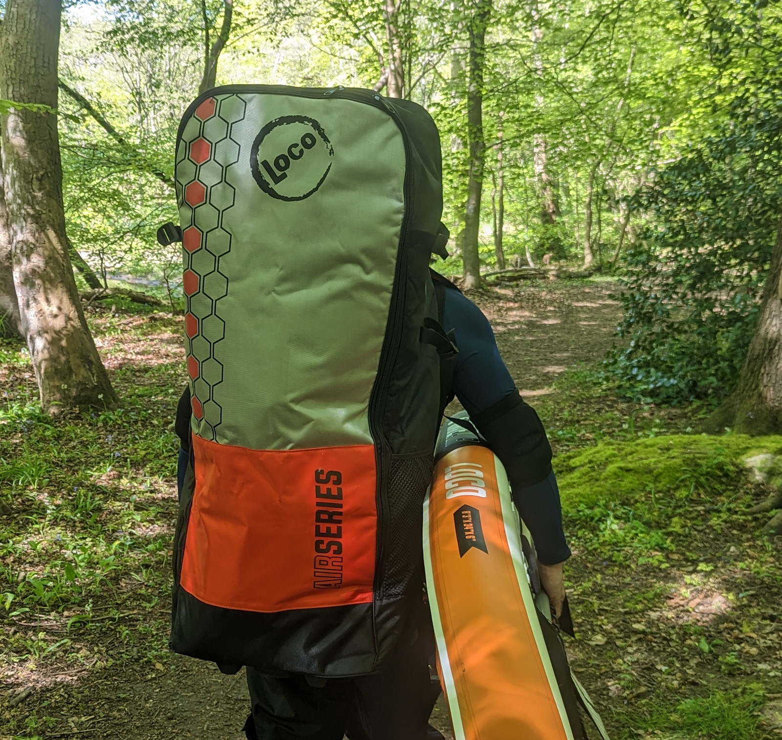 Len Cole carrying SUPs in the woods, Planning Your First SUP Adventure: Tips for an Awesome Journey