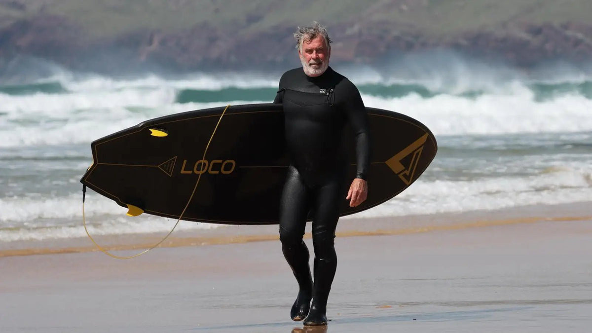 Carbon SUP board beside a UK paddler before launching