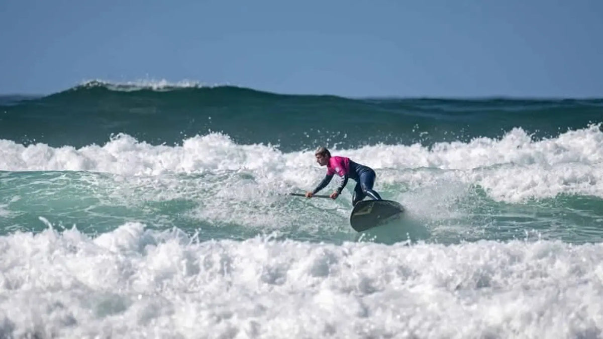 Rider carving a Loco performance surf SUP on a clean UK wave