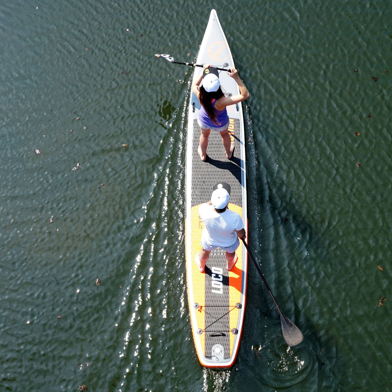 paddle board couple enjoying the river on their tandem SUP board