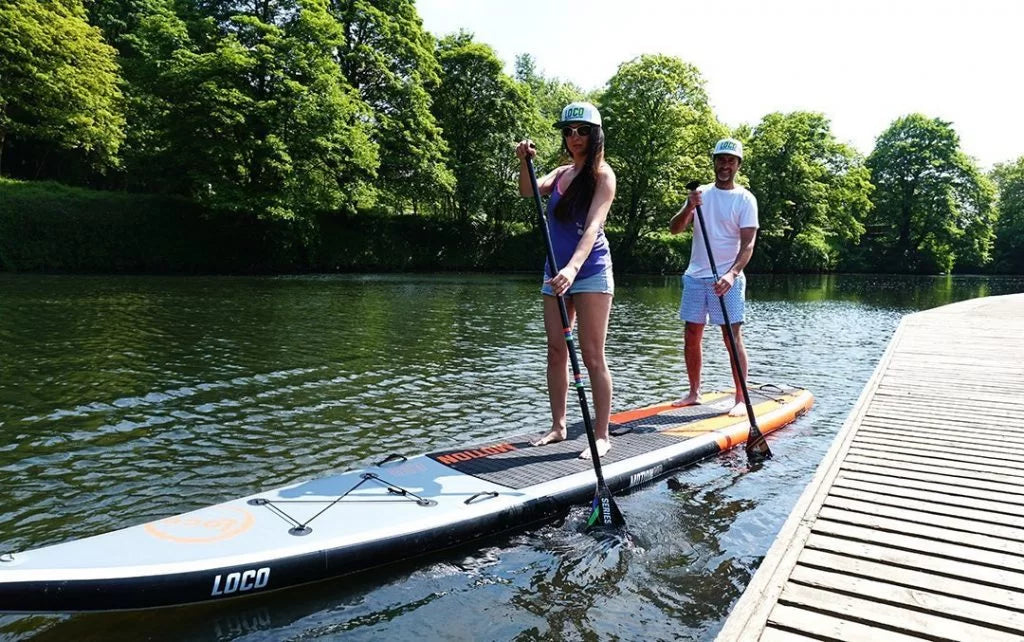 couple with their stand up paddle board at Durham