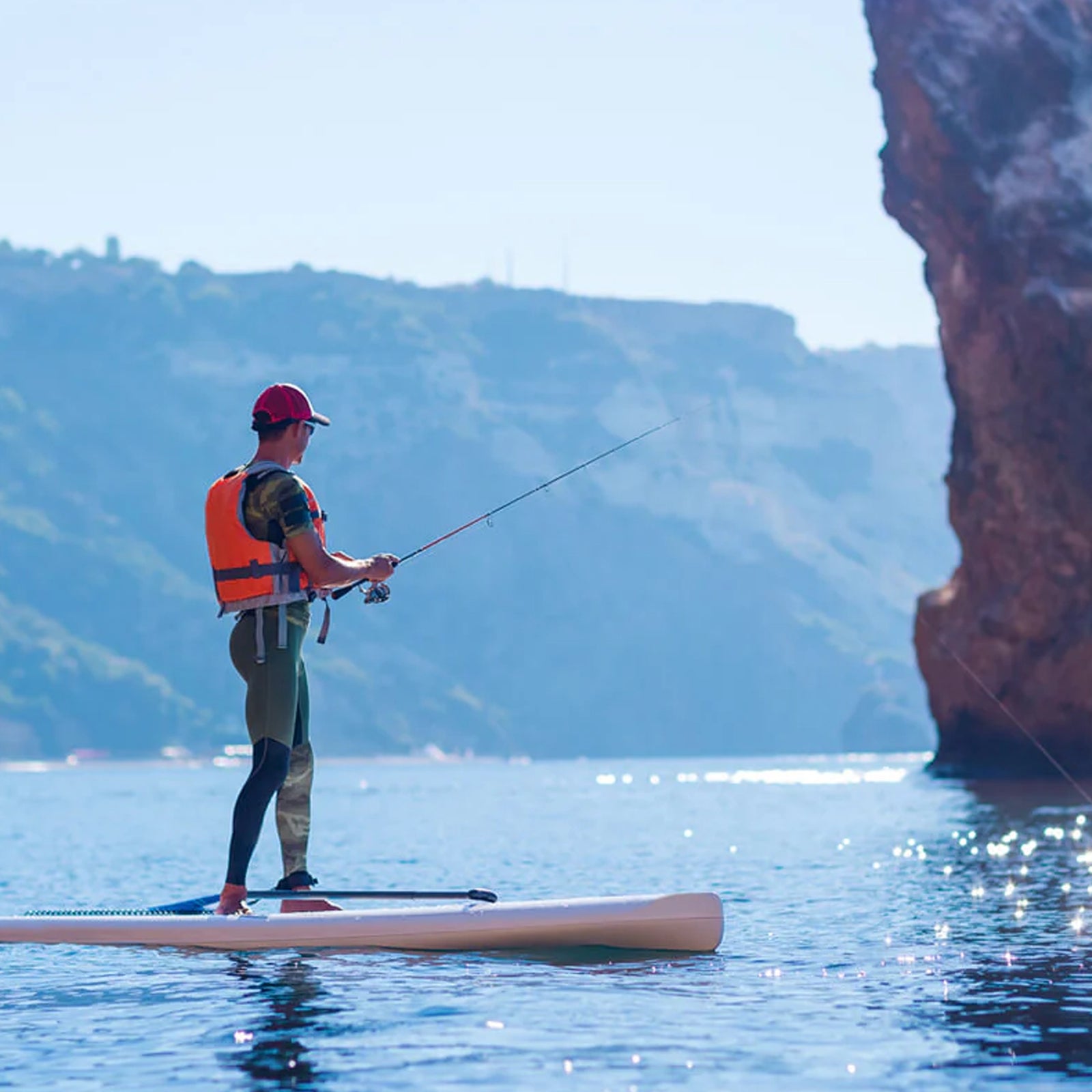 guy fishing on his paddle board