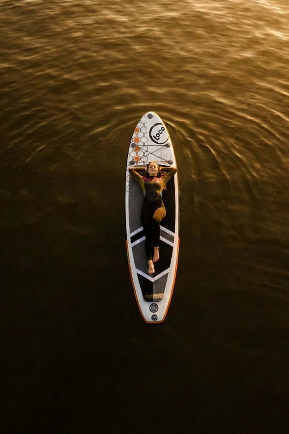 Woman chilling on her paddleboard on the ocean