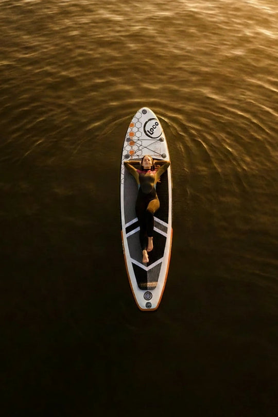Woman chilling on her paddleboard on the ocean