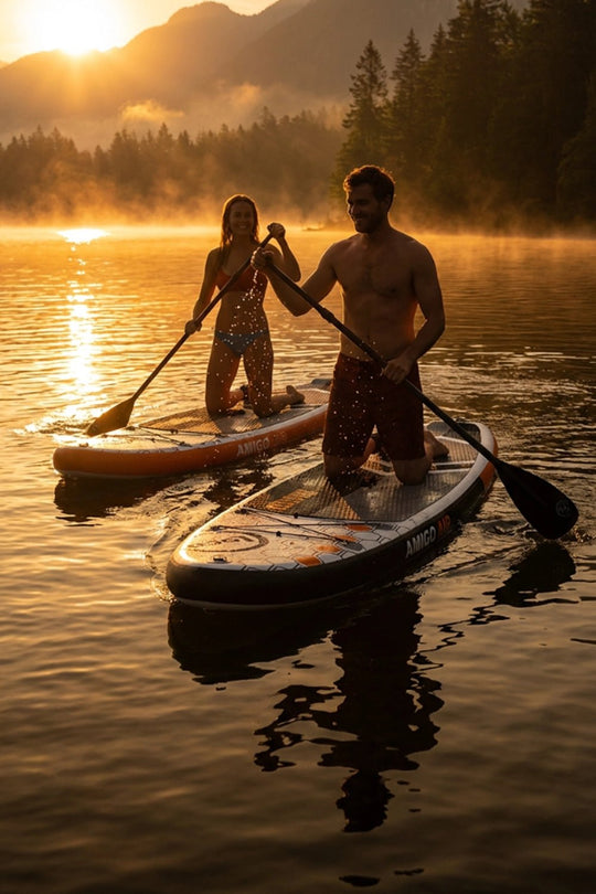 Couple returning to shore on their paddleboards on a lake at golden hour