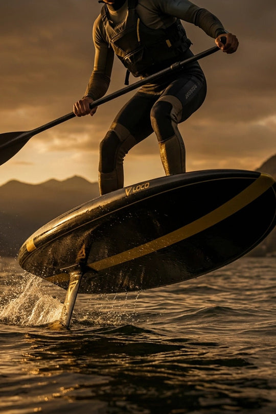 Man paddling his foil board up onto the plane on a lake at dawn