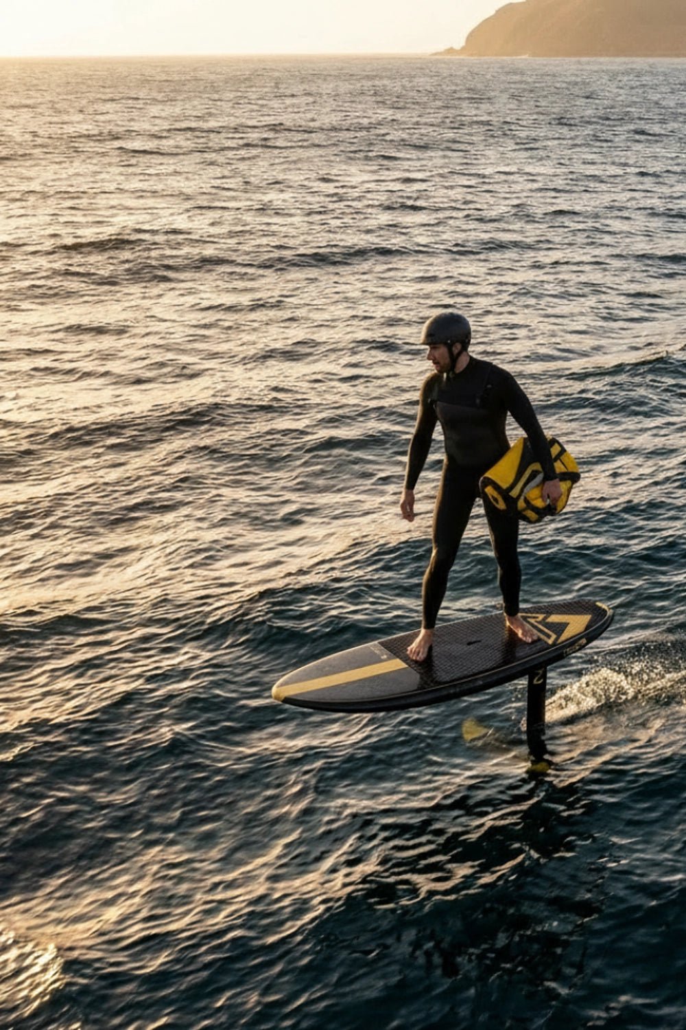 SUP foiler with para-wing rolled up under his arm as he connects the bumps downwind