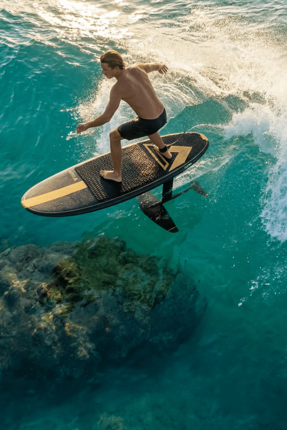 Guy surf foiling over a reef in Bali