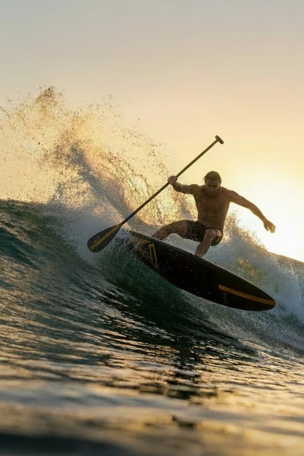 Radical guy SUP boarding on a wave with a sunset in the background